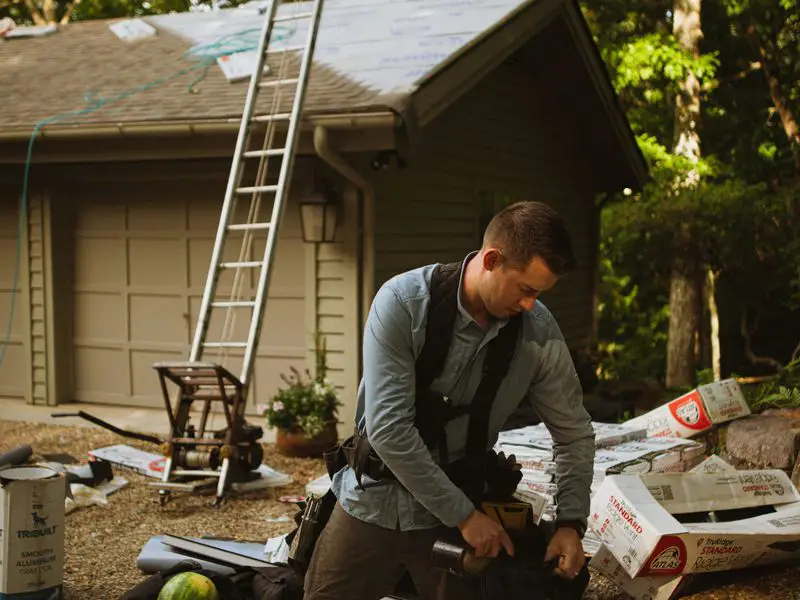 Roofer preparing shingle materials for job